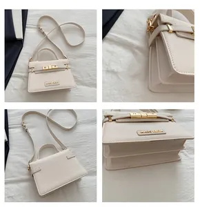 Detail view of cream crossbody bag featuring cross-grain leather and gold metal logo