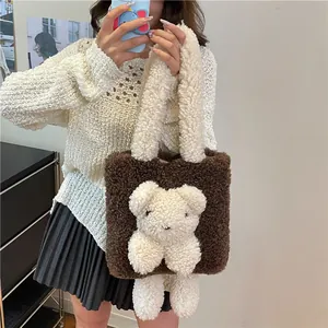 Braune Plüsch-Tragetasche mit weißem Teddybär aus Lammwolle von Model gehalten