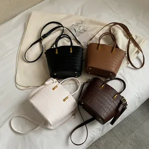 Vintage crocodile pattern bucket bags in four colors with gold top handles and shoulder straps