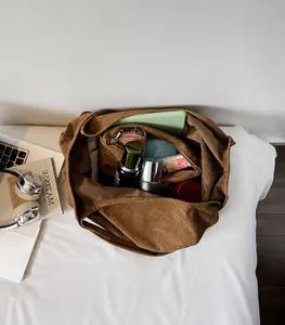 Internal layout of large brown tote bag showing spacious capacity for tablets and wallets