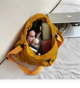 Interior view of yellow nylon crossbody bag filled with daily essentials for large capacity