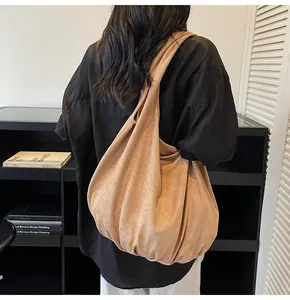 Detail view of large khaki suede tote bag showing soft texture and spacious slouchy design