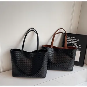 Detailed view of woven checkerboard tote bags in black and brown leather texture