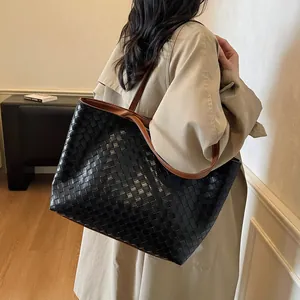 Retro woven leather tote bag with brown straps shown on shoulder for daily commute
