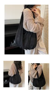 Detail of black suede hobo bag showing soft draping and spacious wide strap design