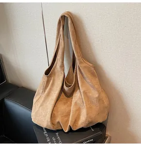 Detailed close-up of large camel suede hobo tote showing soft texture and slouchy design