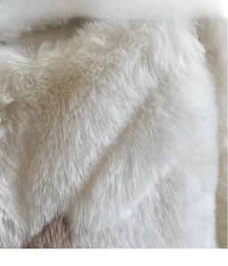 Close-up of white plush faux fur fabric showing soft texture and fluffy material detail