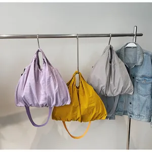 Hanging large capacity nylon canvas shoulder bags in purple, yellow and grey colors
