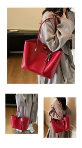 Dettaglio della borsa tote in pelle cerata rossa con chiusura magnetica e logo