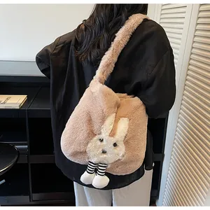 Detail of cute plush rabbit tote bag in apricot pink worn by a model in a minimal room