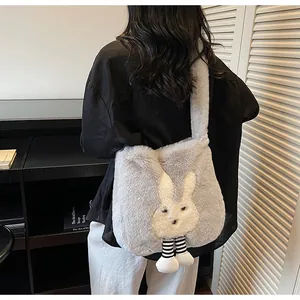 Gray plush rabbit tote bag worn by a model in a stylish indoor setting with soft lighting