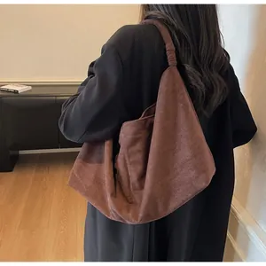 Detailed back view of a dark brown suede hobo bag with a large capacity and minimal design
