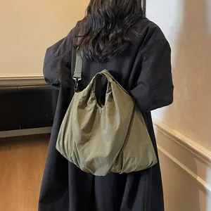 Olive green large canvas tote bag showing a casual slouchy style on a model