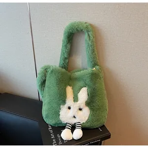 Detail of green plush tote bag featuring a cute white rabbit design and soft fuzzy texture