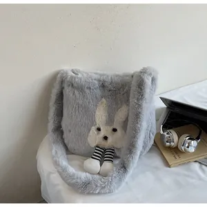 Detail of grey plush tote bag featuring cute rabbit patch and hanging leg accents