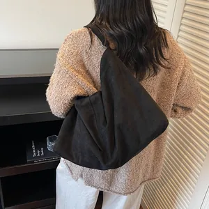 Black matte hobo shoulder bag with large capacity shown in a stylish minimalist side view