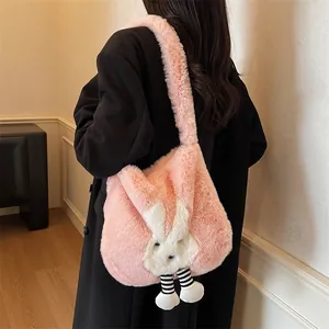 Cute pink plush rabbit tote bag with striped legs shown on a model for autumn outfits