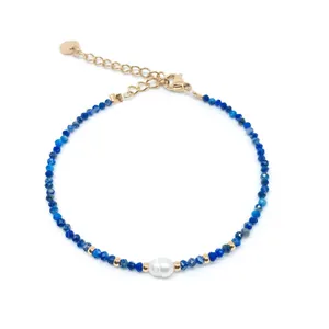 Detail of bohemian natural blue stone bracelet with pearl and 18k gold plated clasp