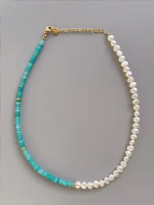 Detail of handmade necklace with light blue stones, freshwater pearls and 18k gold clasp