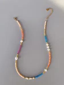 Detail of colorful gemstone beaded necklace with gold lobster clasp and extension chain