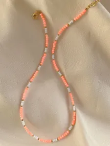Detail of colorful gemstone beads with 18k gold spacers and lobster clasp on silk