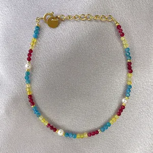 Detail of colorful faceted beads and white pearls bracelet with 18K gold plated clasp