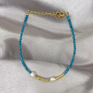 Detail of blue faceted stone beads with baroque pearls and gold-plated titanium steel clasp