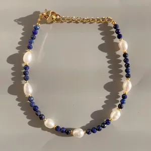 Detail of beaded bracelet with blue natural stone, baroque pearls and gold clasp