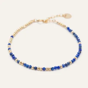 Detail of beaded lapis lazuli bracelet with gold accents and lobster clasp closure