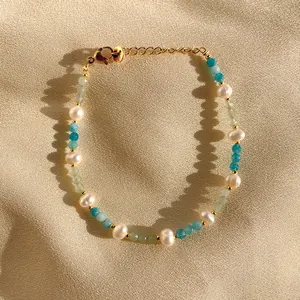 Detail of 18K gold plated bead bracelet with natural pearls and colorful stones