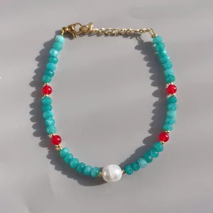 Detail of 18K gold-plated beaded bracelet with blue stone beads and a natural pearl