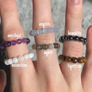 Detail of assorted 4mm natural gemstone beaded rings including Amethyst and Moonstone