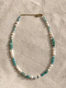 Dettaglio della collana bohémien con pietre irregolari, perle e ciondolo cuore