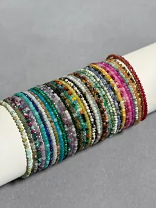 Detail of faceted colorful natural stone beads on 18k gold plated titanium bracelets