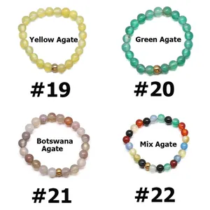 Detail grid of elastic beaded rings with natural agate stones and golden metal charm