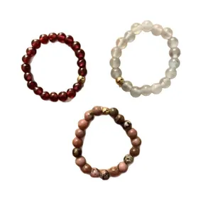 Three-piece set of handmade natural crystal beaded stretch rings with golden accents