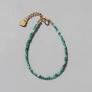 Delicate green natural stone beaded bracelet with 18k gold plated heart charm and extension