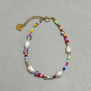 Detail of beaded bracelet with colorful glass beads and natural freshwater pearls