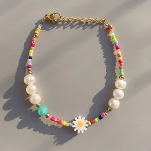 Colorful glass bead bracelet with freshwater pearls and a white daisy pendant charm