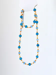 Close-up of blue and orange natural stone bead necklace with white shell and heart charm