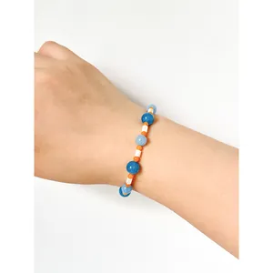 Blue and orange natural stone beaded necklace with white shell in a minimalist style