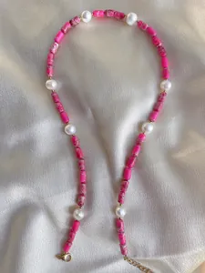 Detail of handmade beaded necklace with pink natural stones and white freshwater pearls