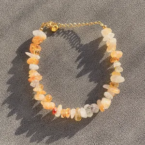 Macro detail of natural citrine and crystal stone beads with golden adjustable clasp
