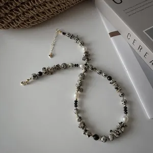 Mixed beaded bracelet with freshwater pearls, dalmatian stones, and gold steel accents
