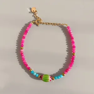 Detailed shot of handmade beaded bracelet with pink and blue stones and freshwater pearls