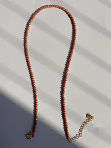 Macro view of sunstone beads and freshwater pearl necklace with adjustable gold clasp