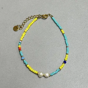 Macro shot of colorful glass beads with freshwater pearls and gold lobster clasp