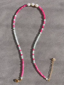 Macro detail of handmade natural stone necklace with freshwater pearls and gold clasps
