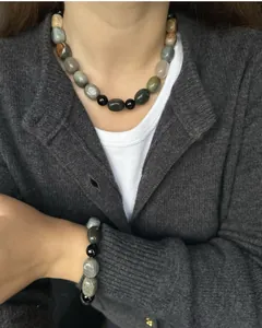 Detailed view of handmade natural stone necklace with vintage oil painting texture
