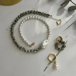 Elegant baroque pearl necklace set with leopard stone accents on marble background